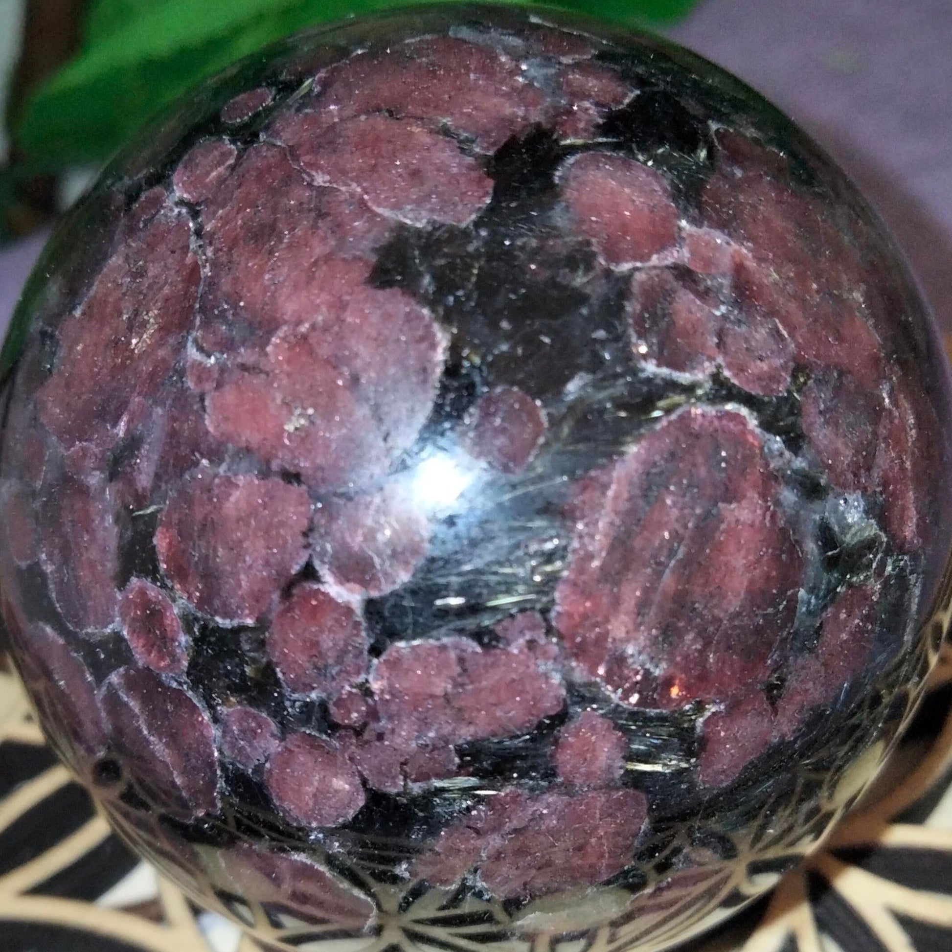 Garnet on astrophyllite sphere gold flash